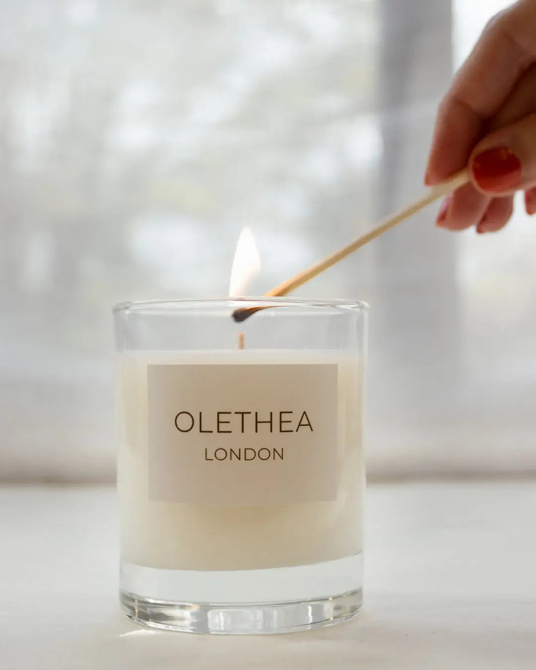 Tropical Serenity - Olethea London - lighting a scented soy wax candle with a match
